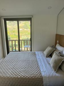a bedroom with a large bed with a large window at maison du olival in Vacalar +71 photos