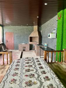 a kitchen with a table and a rug on the floor at Гостевой дом Сафар in Kapchagay