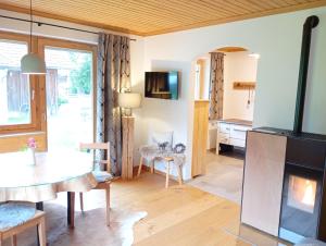 a living room with a table and a dining room at Alpflower in Halblech