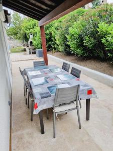ein Tisch und Stühle auf einer Terrasse in der Unterkunft Vacances entre mer et montagne in Alès