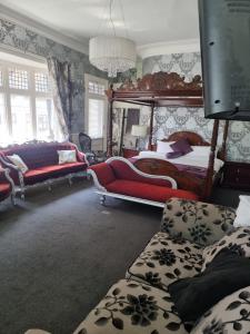 a living room with a bed and a couch at The White Hart Hull in Hull
