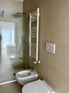 a bathroom with a toilet and a sink and a mirror at Casita in Santo Spirito