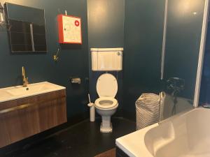 a bathroom with a white toilet and a sink at SEA Villa Rosa Seaside & Garden. in Porto +12 photos