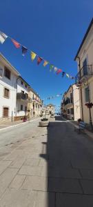 an empty street with flags hanging in a city at La Casetta del Castello in San Vito Chietino