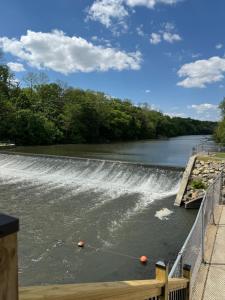 a dam on a river with a waterfall at Sugar on The Sugar River in Albany