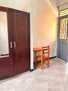 a wooden bench sitting next to a door at Pearls Homes in Moshi