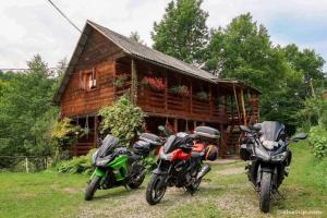 two motorcycles parked in front of a log cabin at Cabana Victor in Sighetu Marmaţiei +94 photos