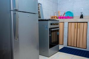 a kitchen with a refrigerator and a stove at Icydunex in Ruiru +4 photos