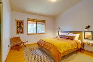 a bedroom with a bed and a chair and a window at Idyllwild Cabin with Deck and Tahquitz Peak Views in Pine Cove