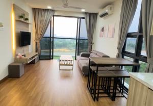 a living room with a couch and a table at Sunset View Condo Cyberjaya in Cyberjaya