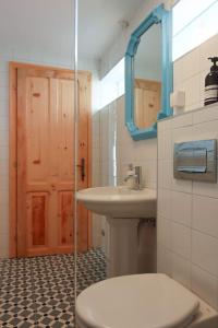 a bathroom with a toilet and a sink at Ankina kućica Vodeničko brdo in Pranjani +18 photos