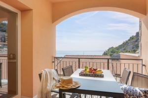 a dining room with a table and a view of the ocean at Portopiccolo Apartments in Sistiana