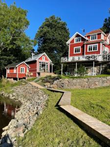 a large red house next to a river at Forest house in Ljungskile