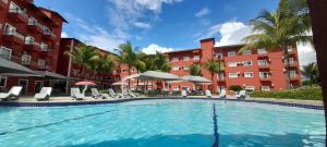 a large swimming pool in front of a building at Lagoa Quente Hotel - LAGOA OFICIAL in Caldas Novas