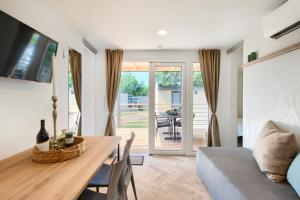 a living room with a table and a couch at Holiday Mobile Homes Park Riviera in Novigrad Istria