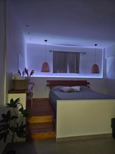 a bedroom with a bed with lights on it at Astravi Rooms in Frý