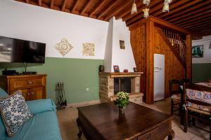 a living room with a couch and a fireplace at Villa Sakura in Lindos