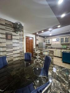a living room with a glass table and chairs at Golden Panorama in Marsa Matruh