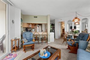 a living room and kitchen with a table and chairs at Dolphins Den in North Topsail Beach