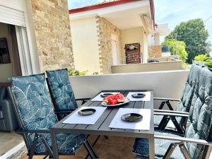 a table on a balcony with a plate of food on it at Nikiti Sunny House in Skála Nikíta