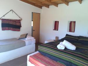 a bedroom with a bed and a dresser at Lodge Altitud in San Pedro de Atacama
