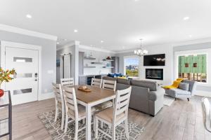 a kitchen and living room with a table and a couch at Dune Our Thing North Topsail Beach in North Topsail Beach