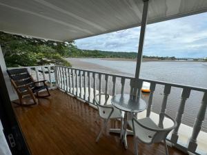a balcony with a table and chairs and the water at Hotel y Restaurante Costa del Sol in Mata de Limón