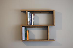 a wooden shelf with books on a wall at Departamento Ventura Puente CECONEXPO in Morelia