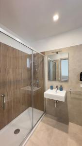 a bathroom with a glass shower and a sink at B&B Vista Mare in San Vito lo Capo