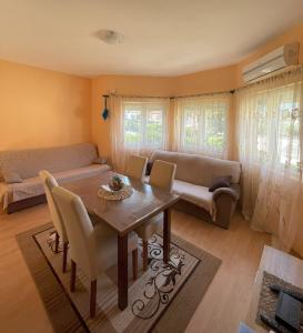 a living room with a table and a couch at Apartments Simic in Kamenari
