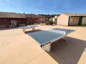 two ping pong tables sitting on a patio at Maison charmante à Soustons avec piscine et jardin in Soustons