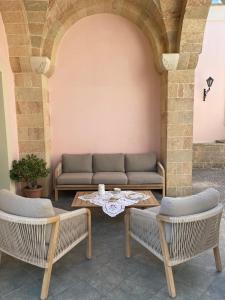 a living room with a couch and a table at La Corte di Zia Lucia - vicino Ospedale Panico - Cammino del Salento in Tricase