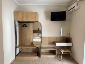 a small bedroom with a bed and a mirror at ANNA ROOMS (Villa Anna) in Nea Vrasna +67 photos