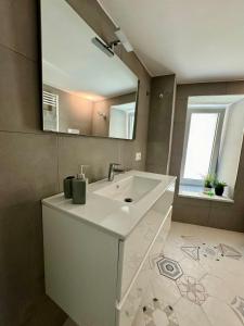 a bathroom with a white sink and a mirror at Residenza d'Artista al Duomo2 in Salerno +40 photos