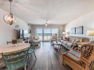a living room with a couch and a table at Queens Grant 211C in Surf City
