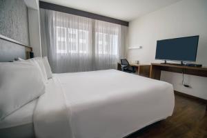Postel nebo postele na pokoji v ubytování Hotel Deville Curitiba