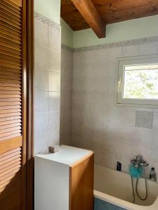 a bathroom with a tub and a sink and a window at La Beata Giovanna in Mesagne
