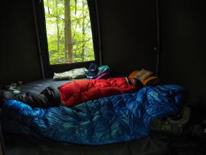 a bed in a room with a window at WisiLas Nad Sercowym Potokiem in Rabka-Zdrój
