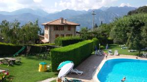 a resort with a swimming pool and a house at Residence Val Di Monte in Malcesine