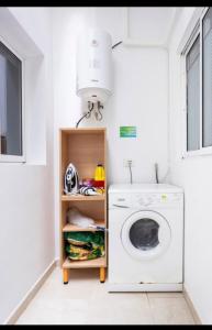 a laundry room with a washing machine and a light at Singol room IN APARTMENT SHARED in Los Cristianos PLAYA Las Vistas in Arona
