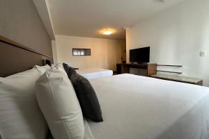 Postel nebo postele na pokoji v ubytování Hotel Deville Curitiba