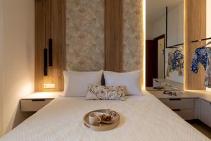 a bed with a tray with a bowl of food on it at Evelyn Villa Crete in Tsoútsouros