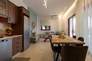 a kitchen and a dining room with a table and a living room at Evelyn Villa Crete in Tsoutsouros
