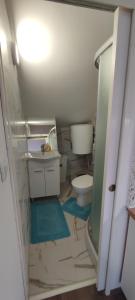 a small bathroom with a toilet and a sink at Apartman BS in Velika Gorica