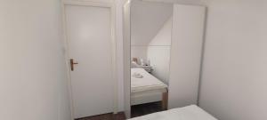 a white bathroom with a mirror and a sink at Apartman BS in Velika Gorica