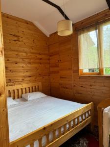 a bedroom in a log cabin with a bed at Verin Tun in Dilijan