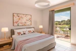 a bedroom with a bed and a sliding glass door at Villa Siora Rosa in Skala