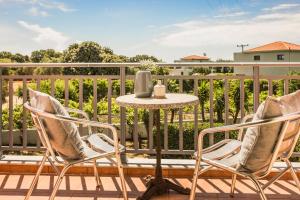 a table and two chairs on a balcony at Villa Siora Rosa in Skala