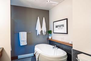 a bathroom with a tub and a sink at Lakefront, Mountain View - 1 Bedroom Resort Suite in Lac-Superieur +24 photos