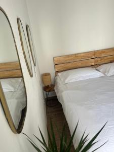 a bedroom with a bed and a plant next to it at La Cuadrita in Casares
